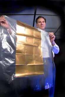 Idaho National Laboratory researcher Steven Novack holds a plastic sheet containing nanoantenna arrays created by embossing the antenna structure and depositing a conductive metal in the pattern